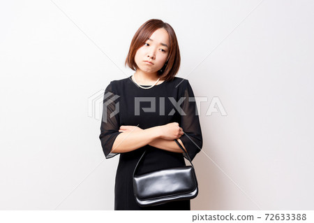 A woman in a mourning pose thinking 72633388
