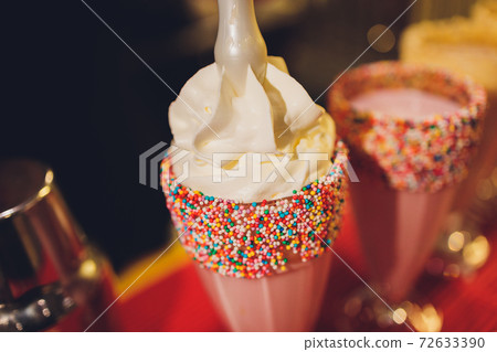 Glasses of milkshake, frappe, ice coffee and smoothie with whipped cream. Glasses of milkshake, frappe, ice coffee and smoothie with whipped cream. 72633390