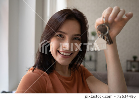 Excited young woman houseowner posing in modern flat holding keys Excited young woman houseowner posing in modern flat holding keys 72634480