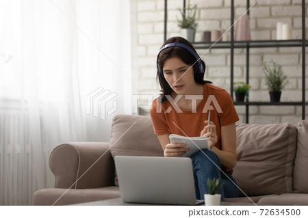 Attentive young woman study from home online at quarantine period Attentive young woman study from home online at quarantine period 72634500