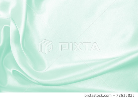 Smooth elegant green silk or satin luxury cloth texture as abstract background. Luxurious background design 72635825