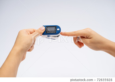 Fingertip Pulse Oximeter on finger. On white background. Device for self health diagnostic Fingertip Pulse Oximeter on finger. On white background. Device for self health diagnostic 72635928