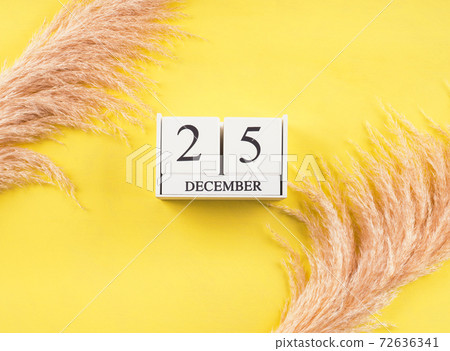 Calendar December,25 date on yellow background Calendar December,25 date on yellow background 72636341
