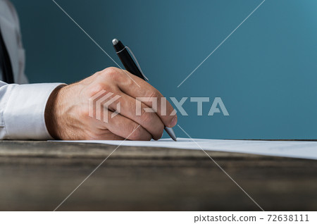 Businessman or lawyer signing a document Businessman or lawyer signing a document 72638111