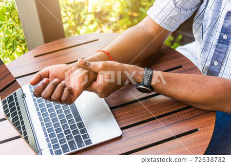 black man holding his wrist pain black man holding his wrist pain 72638782