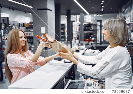 Woman buys dishes in the store Woman buys dishes in the store 72639687