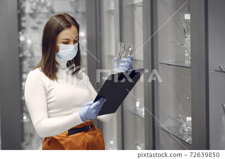 Woman buys dishes in the store 72639850