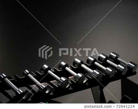 Image of dumbbells / sports gym lined up on the rack 72641224