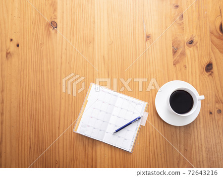 Schedule book and coffee cup 72643216