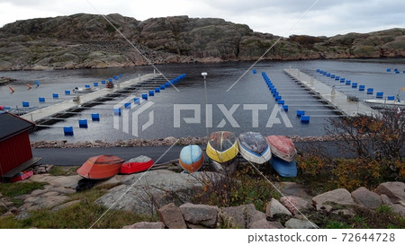 wooden boats on the fishing harbor on the ocean coast in southern Sweden 72644728