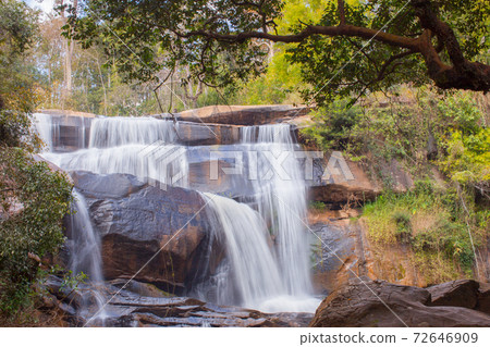 Waterfall with stone foreground in forest Waterfall with stone foreground in forest 72646909