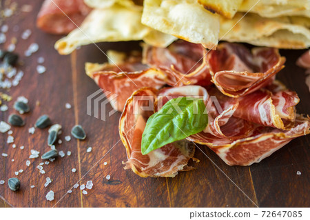 Prosciutto ham and grissini bread sticks. italian antipasto. Shallow dof. 72647085