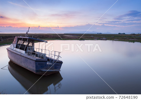 boats floating under colorful sky at sunset time boats floating under colorful sky at sunset time 72648190