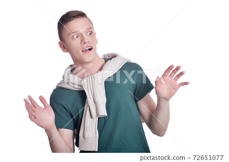 Handsome surprised man posing on white background 72651077
