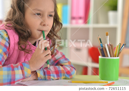 Close up portrait of little girl drawing at her room 72651115
