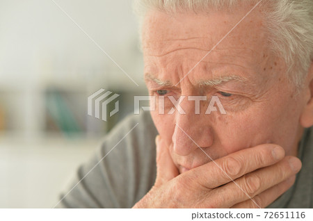 Portrait of sad senior man at home 72651116