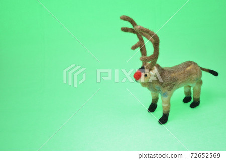 Reindeer facing left on the right side of the green background screen Reindeer facing left on the right side of the green background screen 72652569