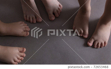 kids barefeet on grey paper. Concept of happiness. 72653468