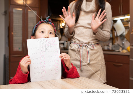 A girl who is praised by her mother for 100 points in the test A girl who is praised by her mother for 100 points in the test 72653521