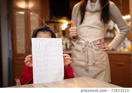 A girl who is praised by her mother for 100 points in the test A girl who is praised by her mother for 100 points in the test 72653523