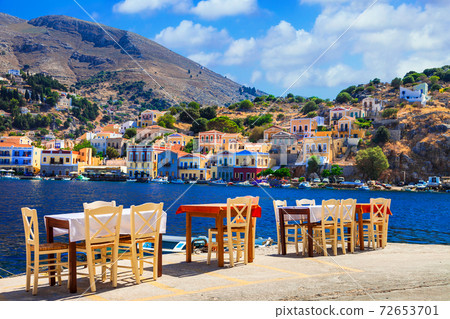 Traditional Greece - small street tavernas in Symi island, Dodecanesse 72653701