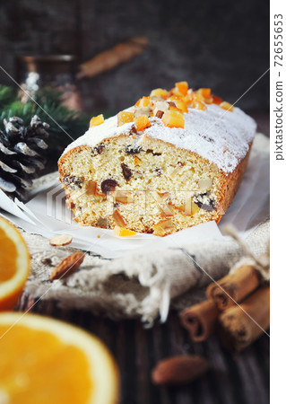 Christmas cake with candied orange and dried fruits, coffee and New Year decoration 72655653