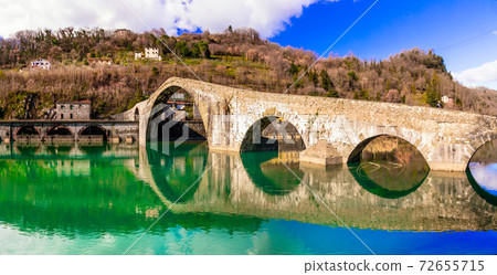 Ponte della Maddalena- picturesque scenery with ancient bridge in the Italian province of Lucca Ponte della Maddalena- picturesque scenery with ancient bridge in the Italian province of Lucca 72655715