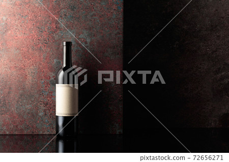 Bottle of red wine on rusty brown background. 72656271