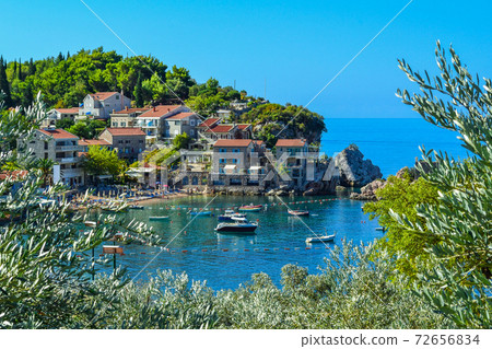 Coastal city. Small old houses with a tiled roof near the sea on the mountain. Montenegro. Adriatic Sea. Coastal city. Small old houses with a tiled roof near the sea on the mountain. Montenegro. Adriatic Sea. 72656834