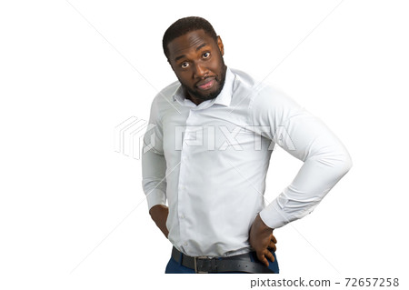 Black man in shirt holding hands on belt. 72657258