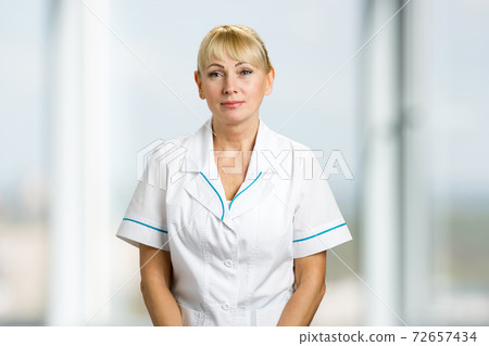 Portrait of nurse in white uniform. Portrait of nurse in white uniform. 72657434