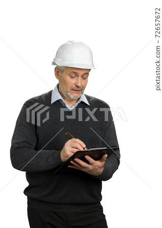 Confident mature supervisor writing on clipboard. Confident mature supervisor writing on clipboard. 72657672