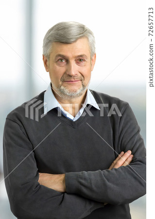 Confident mature man with crossed arms. Confident mature man with crossed arms. 72657713