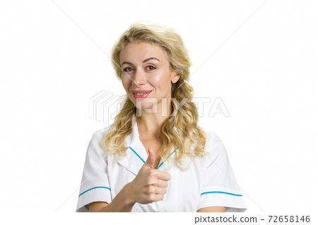 Young nurse showing thumb up. Young nurse showing thumb up. 72658146