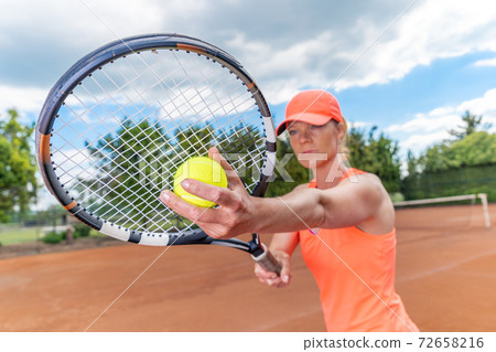 tennis racket in the hand of a young tennis player 72658216