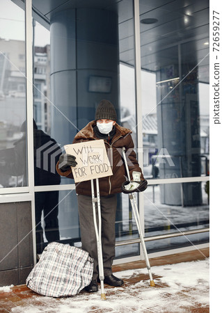Old homeless man in a durty clothes in winter city Old homeless man in a durty clothes in winter city 72659277