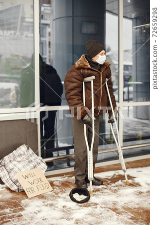 Old homeless man in a durty clothes in winter city Old homeless man in a durty clothes in winter city 72659298