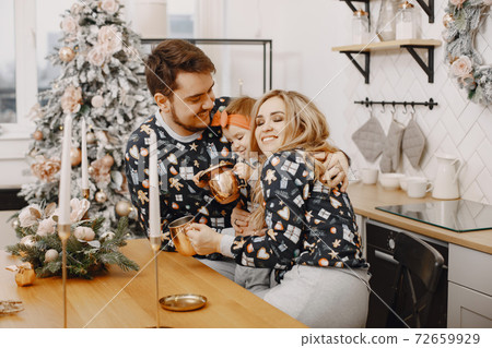 Family in identifical pajamas at home Family in identifical pajamas at home 72659929