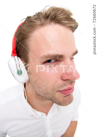 Spy concept. Man listening headphones suspiciously Spy concept. Man listening headphones suspiciously 72660672