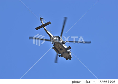 A helicopter flying in the blue sky 72661596