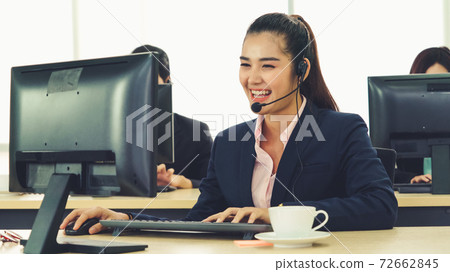 Business people wearing headset working in office Business people wearing headset working in office 72662845