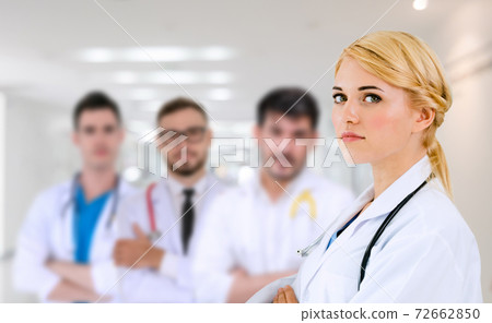 Doctor working in hospital with other doctors. Doctor working in hospital with other doctors. 72662850