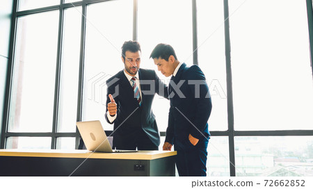 Two business people talk project strategy at office 72662852