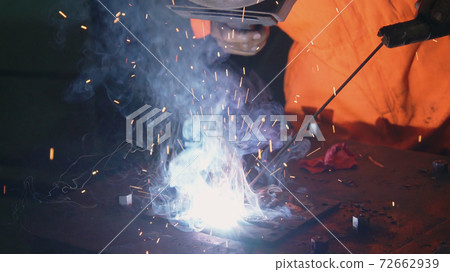 Metal welder working with arc welding machine Metal welder working with arc welding machine 72662939