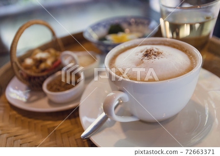 Cappuccino coffee served in a Thai style coffee shop 72663371