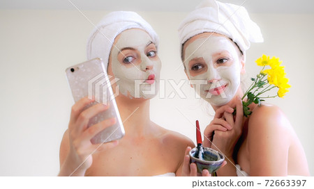 Beautiful woman having a facial treatment at spa. 72663397