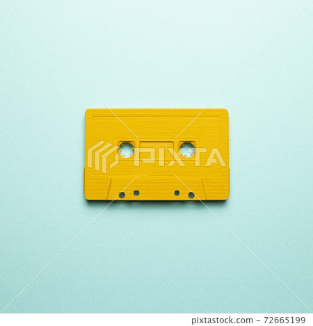 Yellow audio cassette tape on blue background. top view, copy space 72665199