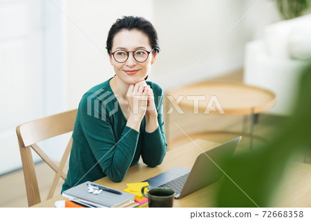 Middle-aged woman working from home 72668358