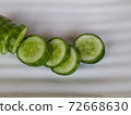Fresh raw  sliced cucumber in white background 72668630