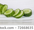 Fresh raw  sliced cucumber in white background 72668635